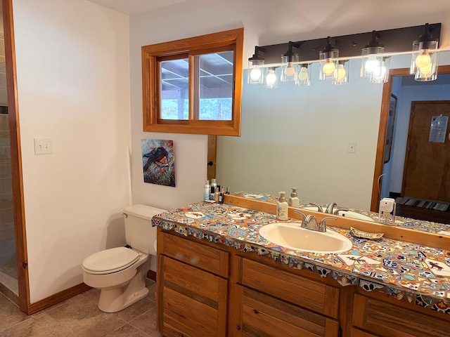 675 Bobcat Ln, Hamilton, MT 59840 - bathroom with vanity, baseboards, tile patterned floors, and toilet