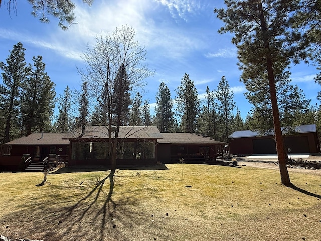 675 Bobcat Ln, Hamilton, MT 59840 - back of house featuring a lawn, an outbuilding, and a wooden deck