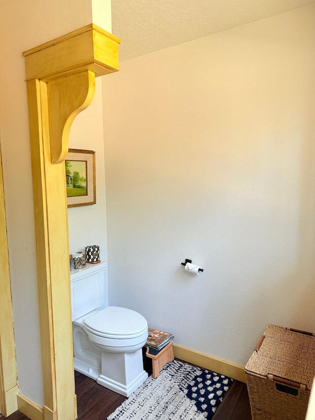 675 Bobcat Ln, Hamilton, MT 59840 - bathroom with baseboards, toilet, and wood finished floors
