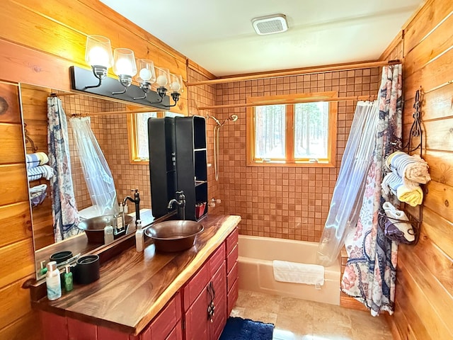 675 Bobcat Ln, Hamilton, MT 59840 - bathroom with vanity, visible vents, wood walls, and shower / bath combination with curtain