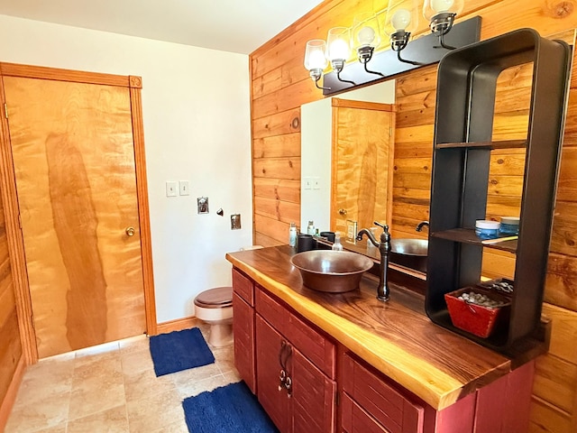 675 Bobcat Ln, Hamilton, MT 59840 - bathroom with wooden walls, vanity, and tile patterned floors