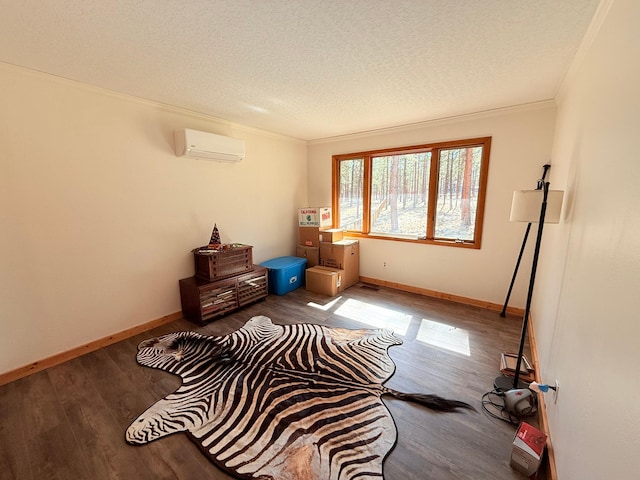 675 Bobcat Ln, Hamilton, MT 59840 - interior space featuring a textured ceiling, a wall mounted AC, wood finished floors, baseboards, and ornamental molding