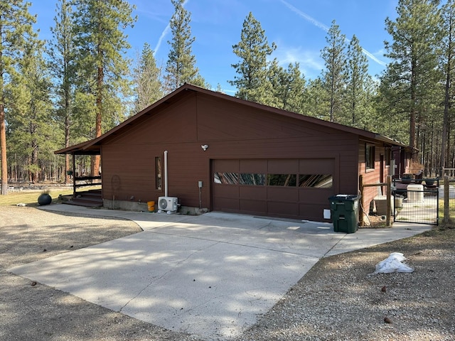 675 Bobcat Ln, Hamilton, MT 59840 - view of side of property with fence, an attached garage, and concrete driveway