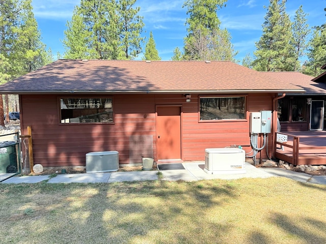 675 Bobcat Ln, Hamilton, MT 59840 - rear view of property with a lawn, fence, a wooden deck, and roof with shingles