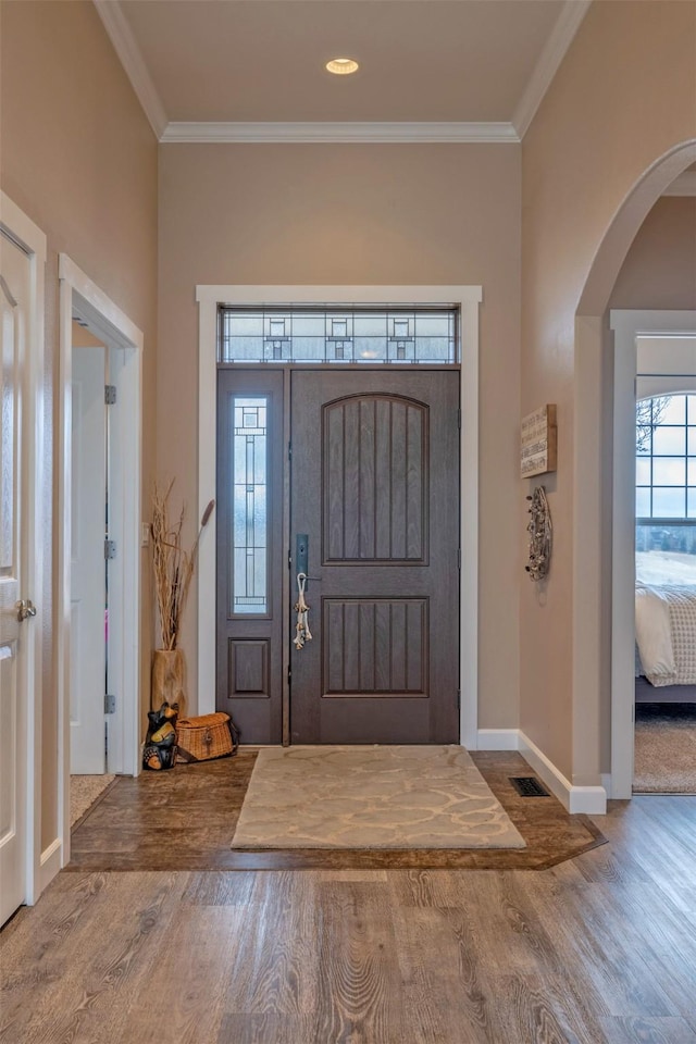 24 Sidewinder Loop, Clancy, MT 59634 - foyer with wood finished floors, arched walkways, and crown molding
