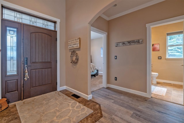 24 Sidewinder Loop, Clancy, MT 59634 - entryway with crown molding, arched walkways, and wood finished floors