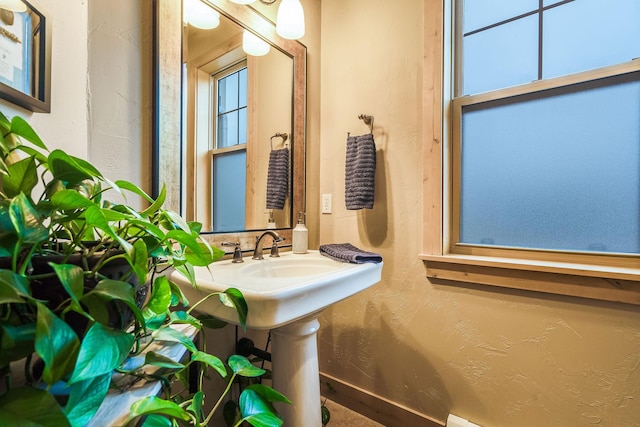 half bath featuring a textured wall