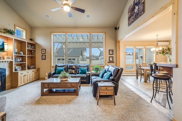 living room with light tile patterned flooring, ceiling fan with notable chandelier, high vaulted ceiling, and light colored carpet