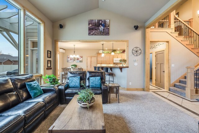 230 Camp Crook Ave, Kalispell, MT 59901 - carpeted living room featuring ceiling fan, a fireplace, healthy amount of natural light, baseboards, and high vaulted ceiling