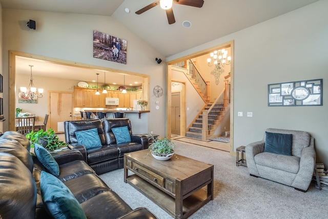 living room with high vaulted ceiling, stairway, carpet, and ceiling fan with notable chandelier