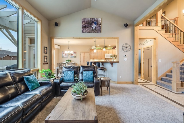 carpeted living area with baseboards, stairs, high vaulted ceiling, and a chandelier