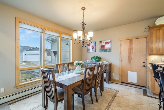 dining room featuring light tile patterned floors, a baseboard heating unit, and a chandelier