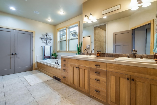 full bathroom with tile patterned floors, visible vents, a sink, and a bath