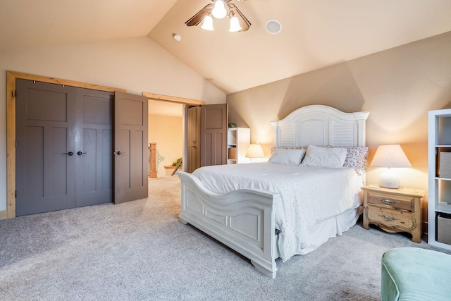 bedroom featuring high vaulted ceiling, connected bathroom, light colored carpet, and ceiling fan