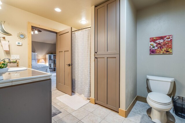 230 Camp Crook Ave, Kalispell, MT 59901 - bedroom featuring light colored carpet, vaulted ceiling, connected bathroom, freestanding refrigerator, and a ceiling fan