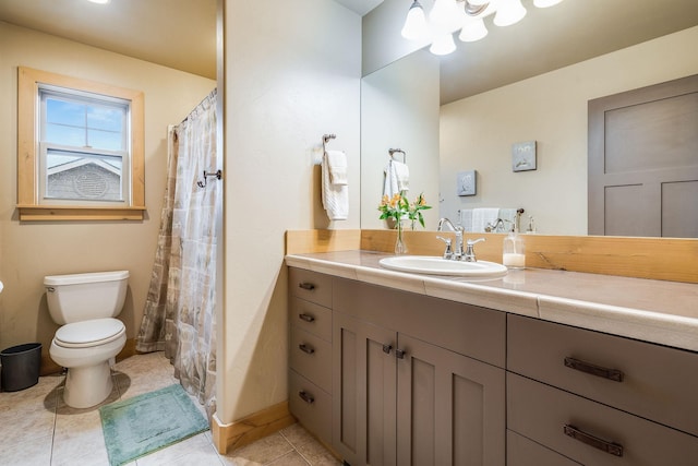 full bathroom featuring toilet, tile patterned flooring, and vanity