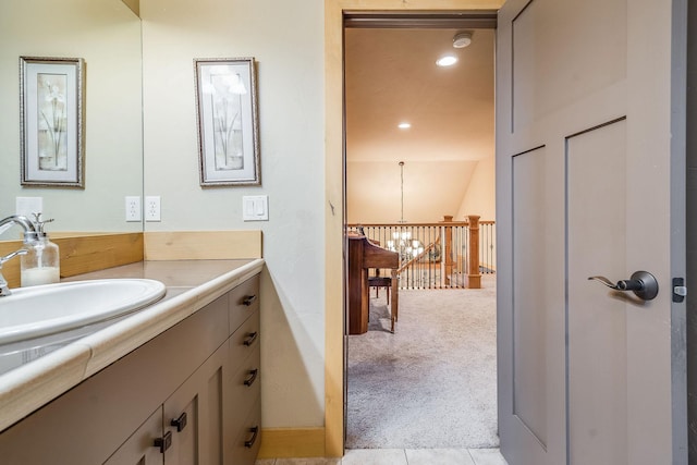 bathroom featuring recessed lighting, tile patterned flooring, vanity, and an inviting chandelier