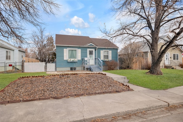 bungalow-style home with a gate, fence, and a front lawn