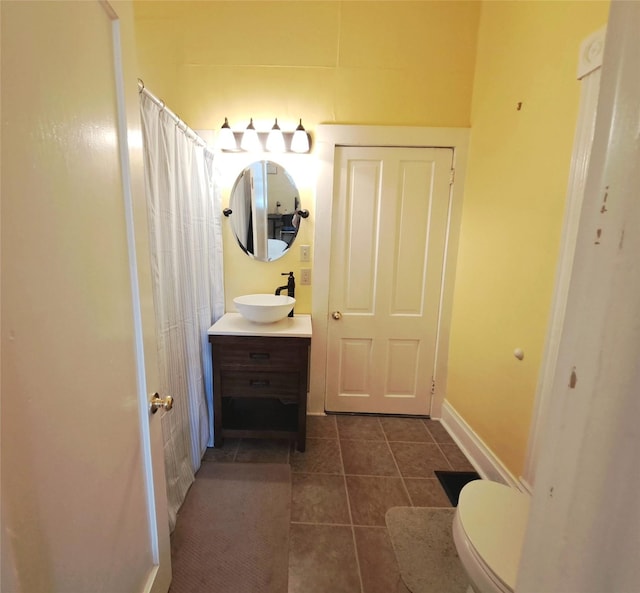 1026 11th Ave, Helena, MT 59601 - bathroom with tile patterned flooring, vanity, toilet, a shower with shower curtain, and baseboards