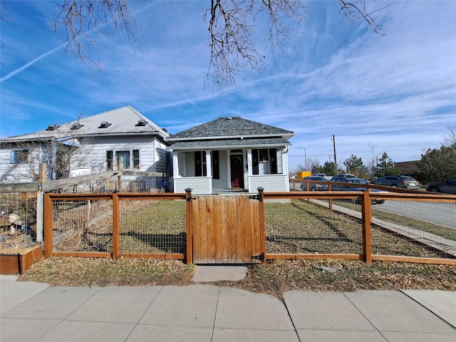 1026 11th Ave, Helena, MT 59601 - bungalow with a fenced front yard, covered porch, and a gate