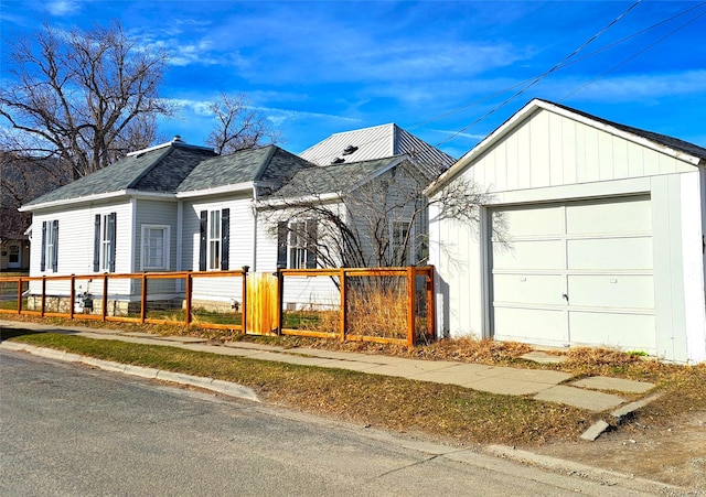 1026 11th Ave, Helena, MT 59601 - view of front facade with a garage, a shingled roof, and an outdoor structure