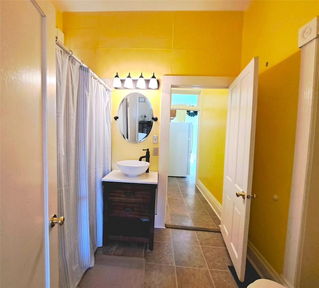 1026 11th Ave, Helena, MT 59601 - bathroom with vanity, tile patterned flooring, a shower with shower curtain, and baseboards