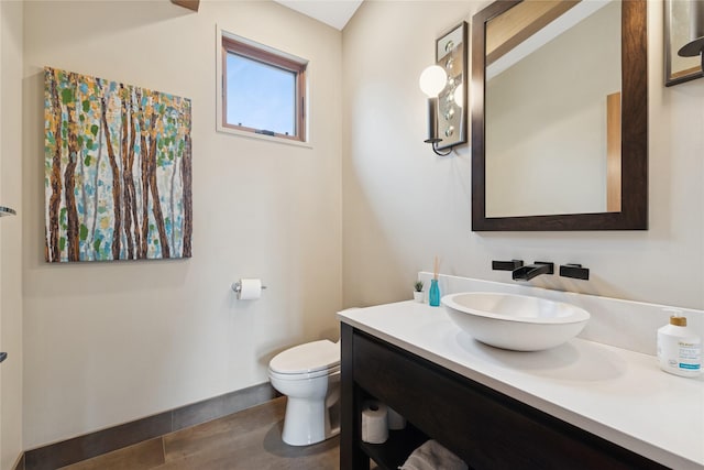 280 Cowgirl Cv, Eureka, MT 59917 - half bathroom featuring toilet, vanity, and wood finished floors