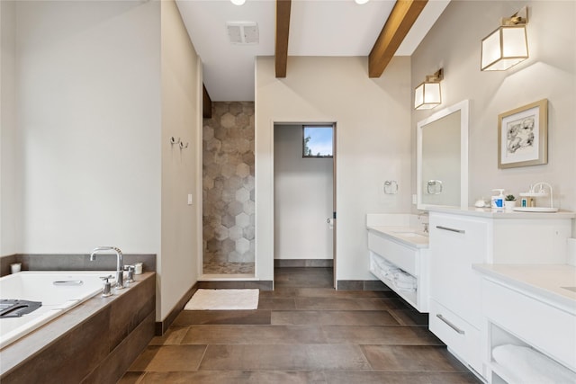 280 Cowgirl Cv, Eureka, MT 59917 - bathroom featuring tiled shower, beam ceiling, vanity, a bath, and visible vents