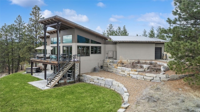 280 Cowgirl Cv, Eureka, MT 59917 - rear view of house featuring stairs, a wooden deck, metal roof, and a yard