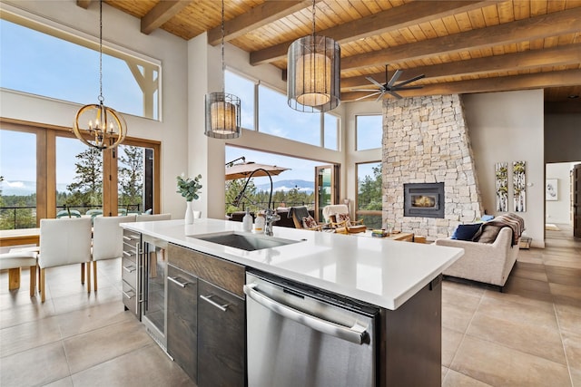 280 Cowgirl Cv, Eureka, MT 59917 - kitchen featuring light countertops, a stone fireplace, pendant lighting, stainless steel dishwasher, and wooden ceiling