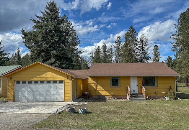 ranch-style home with driveway, a garage, and a front yard