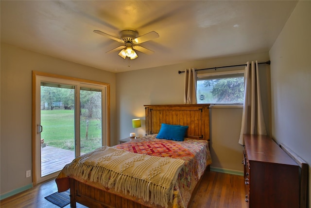 bedroom featuring baseboards, wood finished floors, and access to outside