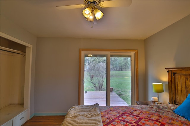 bedroom featuring a ceiling fan, baseboards, access to exterior, and wood finished floors