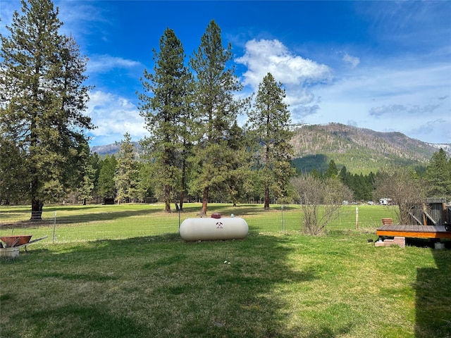 view of yard with a mountain view and fence