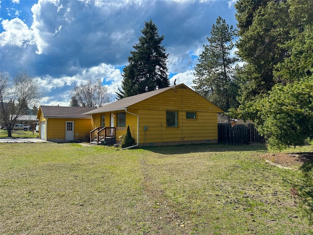 exterior space with a garage, fence, crawl space, and a yard