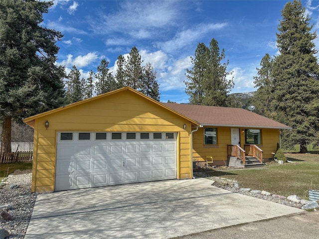 ranch-style house with driveway and an attached garage