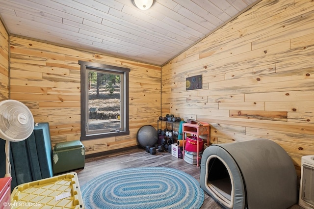 interior space with wooden ceiling, wood walls, lofted ceiling, and wood finished floors
