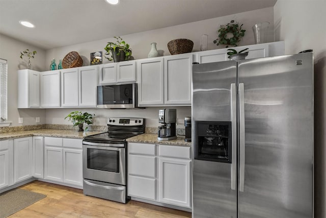 4239 W Babcock St Unit 7, Bozeman, MT 59718 - kitchen featuring white cabinetry, light stone countertops, appliances with stainless steel finishes, light wood-type flooring, and recessed lighting
