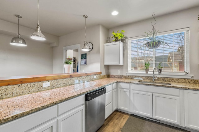4239 W Babcock St Unit 7, Bozeman, MT 59718 - kitchen with a sink, light wood-style floors, pendant lighting, dishwasher, and white cabinets