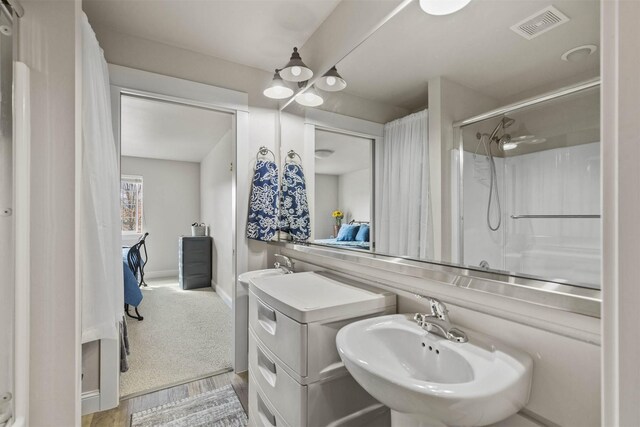 4239 W Babcock St Unit 7, Bozeman, MT 59718 - full bathroom with a sink, baseboards, a shower with shower door, and visible vents