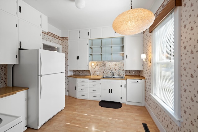 744 2nd Ave W, Kalispell, MT 59901 - kitchen with white appliances, wallpapered walls, light wood finished floors, open shelves, and white cabinets