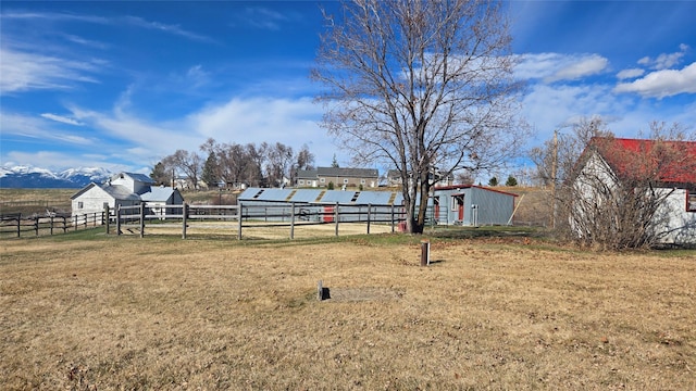 view of yard featuring fence and an outbuilding