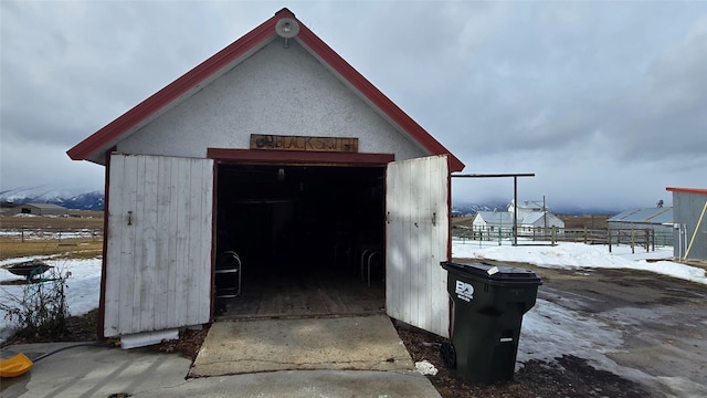 view of outbuilding featuring an outbuilding and fence