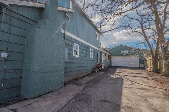 602 16th Ave E, Polson, MT 59860 - view of side of home with a garage, driveway, and an outbuilding