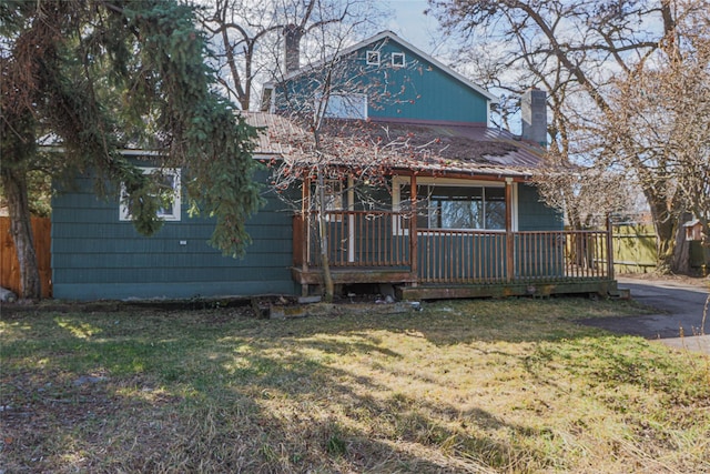 602 16th Ave E, Polson, MT 59860 - view of front of property with a chimney and a deck