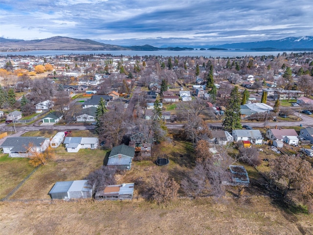 602 16th Ave E, Polson, MT 59860 - aerial view of property and surrounding area featuring a mountainous background and nearby suburban area
