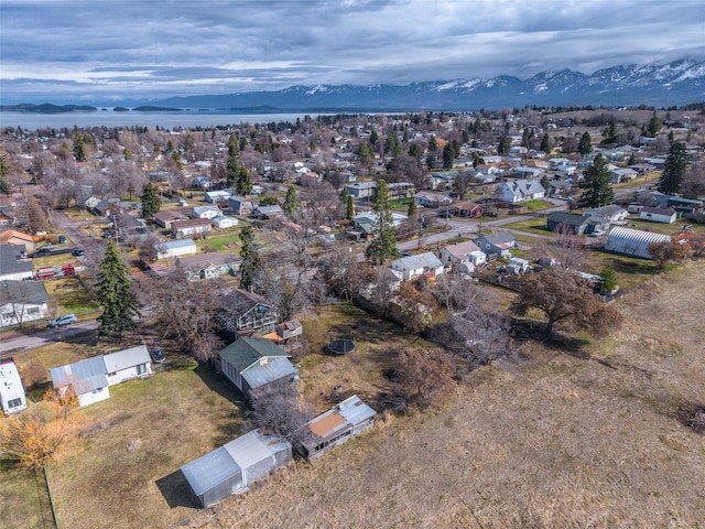 602 16th Ave E, Polson, MT 59860 - aerial overview of property's location featuring a mountainous background and nearby suburban area
