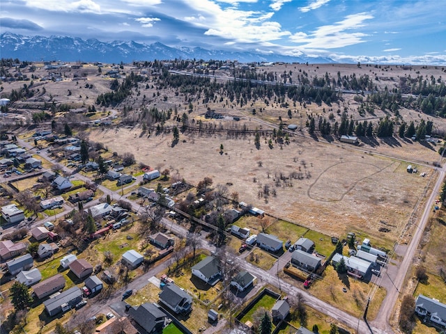 602 16th Ave E, Polson, MT 59860 - aerial view of property's location with a mountain backdrop and rural landscape