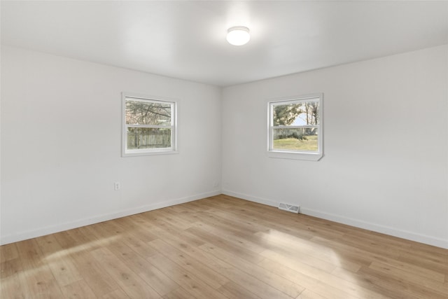 602 16th Ave E, Polson, MT 59860 - empty room featuring plenty of natural light, light wood finished floors, and baseboards