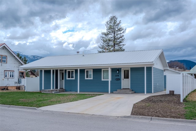 308 Dakota Ave, Libby, MT 59923 - single story home featuring metal roof, covered porch, fence, and driveway